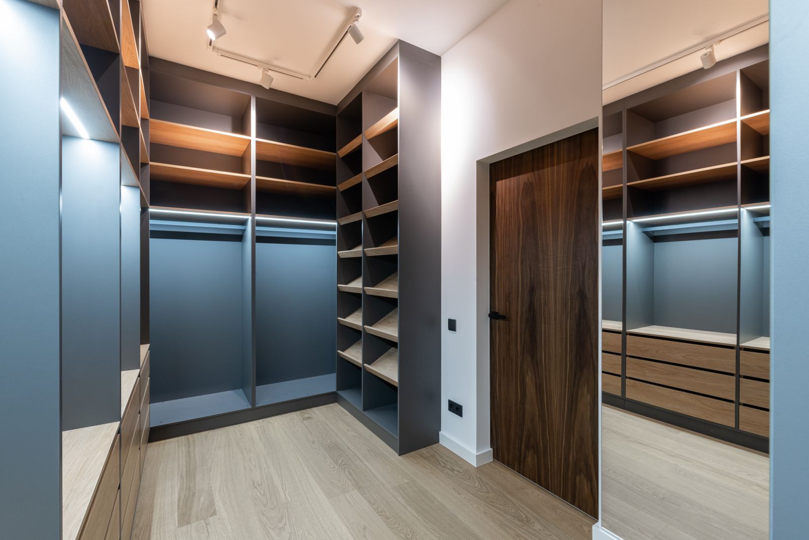 Organized custom walk-in closet with wood shelving